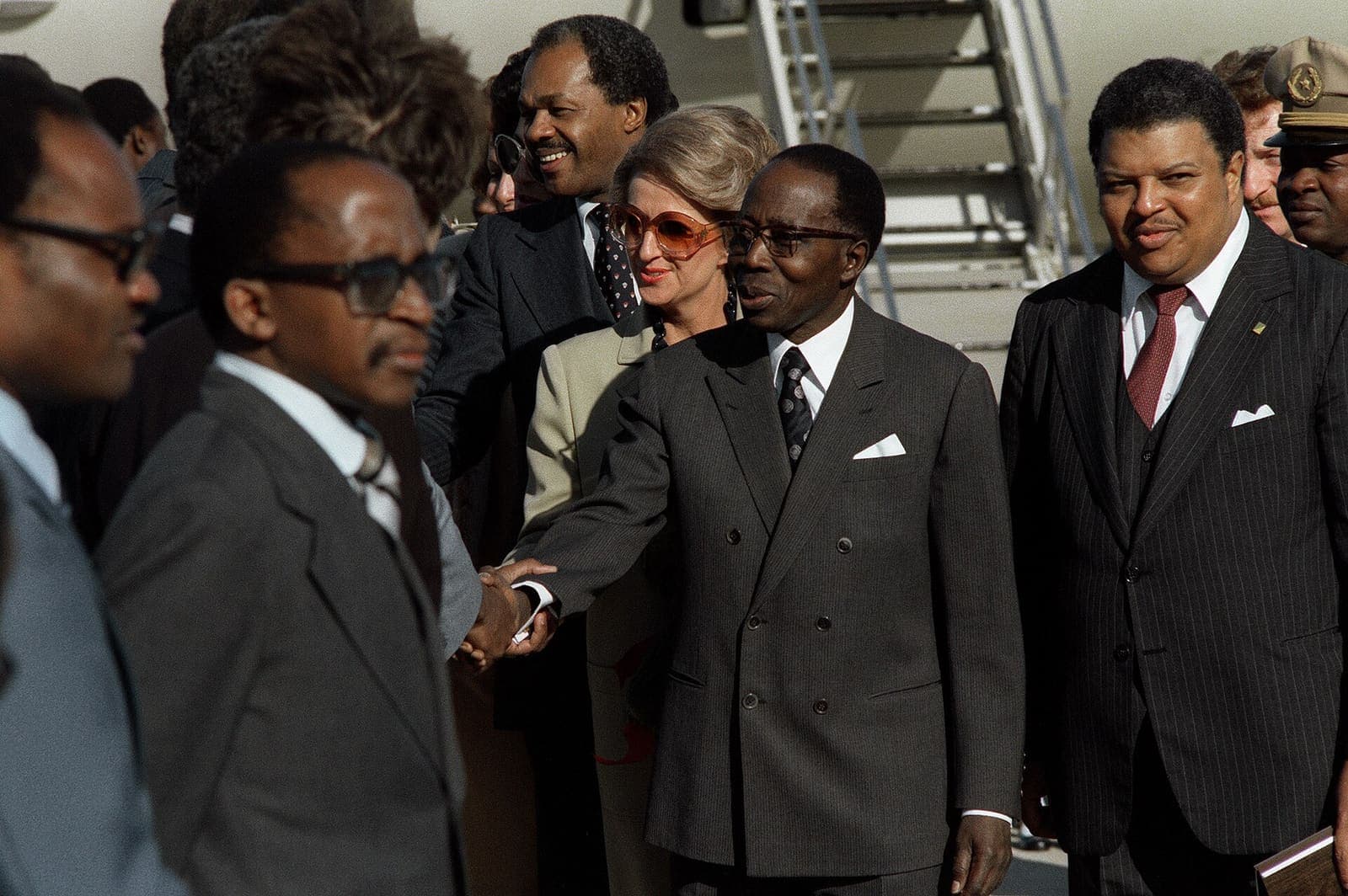 A group of officials greeting one another on arrival.